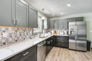 a kitchen with a stainless steel refrigerator and wooden floors at Wausau Home with Yard 1 Mi to Granite Peak Ski Area in Wausau