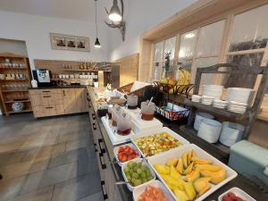 a kitchen with several trays of fruits and vegetables at Ehringer Hof in Polling