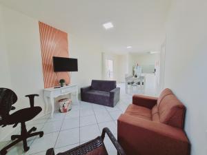 sala de estar con sofá y silla en Residencial Cristina's-Apartamentos de 2-3 Quartos equipados com WiFi Garagem-Excelente Localização, en Lages