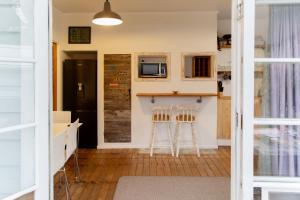 a kitchen with a counter and two stools at Devon Eleven in Rotorua