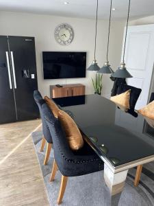 a dining room with a table and some chairs at The American style house in Kent