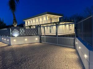 a house with a white gate with lights at La casa dei Coloni in Nola