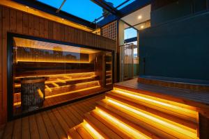 a sauna with wooden floors and lights in a building at Celestino Boutique Hotel in Medellín