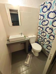 a bathroom with a toilet and a sink and a mirror at Spasmata Apartments no cooking in Minia