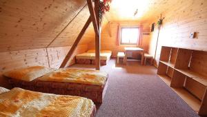 a room with three beds in a wooden cabin at chata Pohoda, chata Kvítek, chata Western 