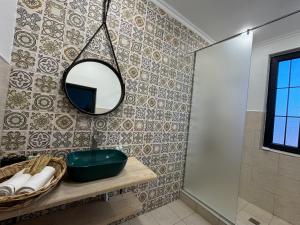 a bathroom with a mirror and a sink at Edits Home in Dsegh