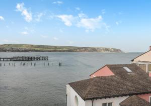 a view of a body of water with houses at Ballard View Apartment in Swanage