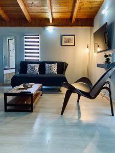 a living room with a couch and a coffee table at Keskos Luxury Apartment in Athens