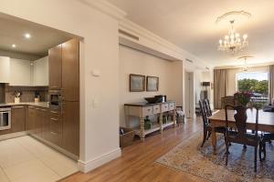 a kitchen and dining room with a dining table and a dining room at Cape Royale Luxury Apartments by Stay In Luxury in Cape Town