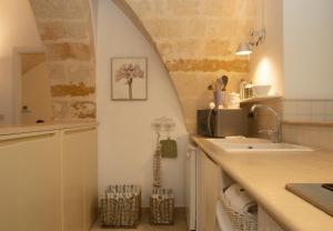 a kitchen with a sink and a counter top at Casa delle Volte - The Fab Stay in Brindisi