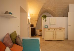 a living room with a couch and a table at Casa delle Volte - The Fab Stay in Brindisi