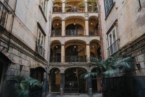 ナポリにあるPalazzo Pandola - Luxury Suitesのヤシの木がある古い建物