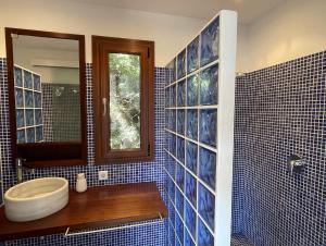 uma casa de banho com WC e uma parede de azulejos azuis em Apto. Ses Ancolles Vistas Mar em Cala Morell