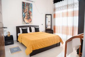 a bedroom with a bed with a yellow comforter at Villa Water View in Bandaragama +42 photos