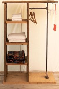 a wooden shelf with towels and towels on it at Homegrown Hideaway in Port Dover