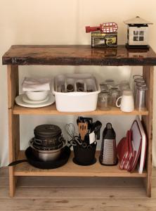 a wooden shelf with dishes and utensils on it at Homegrown Hideaway in Port Dover