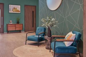 a lobby with two chairs and a table and a vase with flowers at Sonder at Britain Quay in Dublin