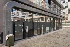 an entrance to a building with glass doors and a suitcase at Sonder at Britain Quay in Dublin