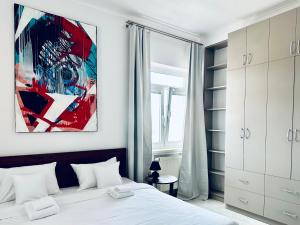 a bedroom with a bed and a painting on the wall at CARLA comfort stay with 2 bathrooms in Košice