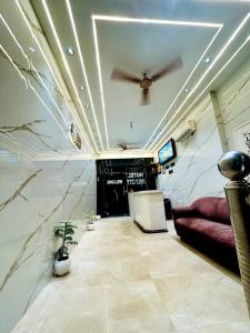 a living room with a couch and a ceiling fan at HOTEL HOLY CITY in Amritsar