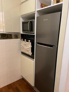 a small kitchen with a refrigerator and a microwave at Ca Bea in Alassio