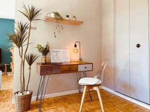 a desk with a chair in a room with plants at L'Oasis -T4 Garage Clim Terrasse WIFI Centre-Ville in Villefranche-sur-Saône