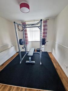 an empty room with a gym with a treadmill at Beautiful 3BR Home with Garden & Gym in Hull