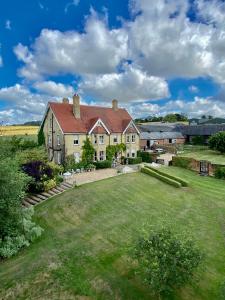 a large house with a large lawn in front of it at Lodge Farm Bed & Breakfast in Hitchin