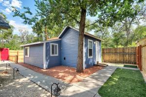 a blue tiny house with a tree in the yard at Charming Half Pint Downtown Stay Pet Friendly in Colorado Springs