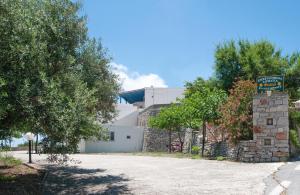 a building with a sign on the side of a road at Filio rooms in Kythira