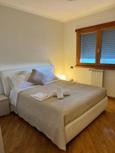 a bedroom with a bed with two towels on it at DolceVita Eur Torrino Prestige in Rome