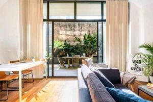 a living room with a couch and a table at 1 bedroom Apartment with private pool in Sydney