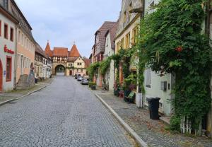 a cobblestone street in an old town with buildings at Luitpold14 Prichsenstadt in Prichsenstadt