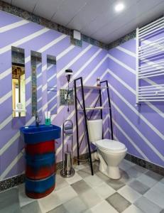 een paarse badkamer met een toilet en een wastafel bij Paradiso Hotel in Telavi