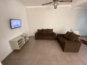 a living room with a couch and a tv at Casa Comendador in Uberlândia