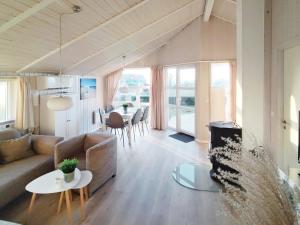 a living room with a couch and a table at 4 person holiday home in Gelting in Gelting