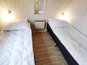 two twin beds in a room with a radiator at 4 person holiday home in Gelting in Gelting