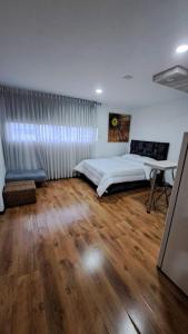 a bedroom with a bed and a desk in it at Yellow House in Manizales