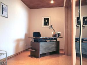 an office with a desk with a lamp on it at Holiday apartment Sunflower in Marpingen