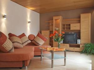 a living room with a couch and a tv at Holiday apartment Sunflower in Marpingen