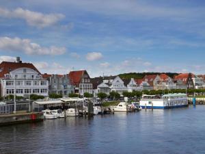 a group of boats docked in a harbor with houses at Houseboat Possibility 7 in Travemünde