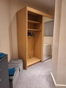 a room with a closet with a bed in it at Fabulous Home from Home - Central Long Eaton - Lovely Short-Stay Apartment - HIGH SPEED FIBRE OPTIC BROADBAND INTERNET - HIGH SPEED STREAMING POSSIBLE Suitable for working from home and students Very Spacious FREE PARKING nearby in Long Eaton