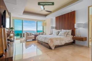 a bedroom with a bed and a view of the ocean at Shangri-La Torre5-7B-PV in Puerto Vallarta