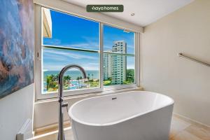 a bath tub in a bathroom with a large window at Shangri-La Torre5-7B-PV in Puerto Vallarta