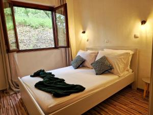 - un lit avec couverture dans une chambre avec fenêtre dans l'établissement Holiday Home Omindula, à Jesenice