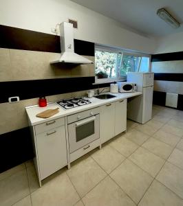 a kitchen with a stove and a refrigerator at IL GLICINE CAMPAGNOLO in Atessa
