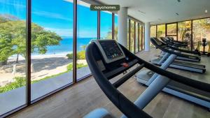 a gym with a row of treadmills and the ocean at 03 F2 Bolongo-PV in Punta Mita