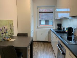 a kitchen with a table and a counter top at BestBoarding24 in Schöllkrippen