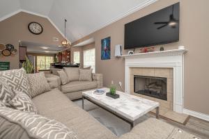 a living room with a couch and a fireplace at Wanderlust Willow Trussville Youth Sports Park in Birmingham