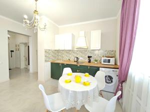 a kitchen with a white table with fruit on it at ЖК ATREA 2 room Apartment in Almaty
